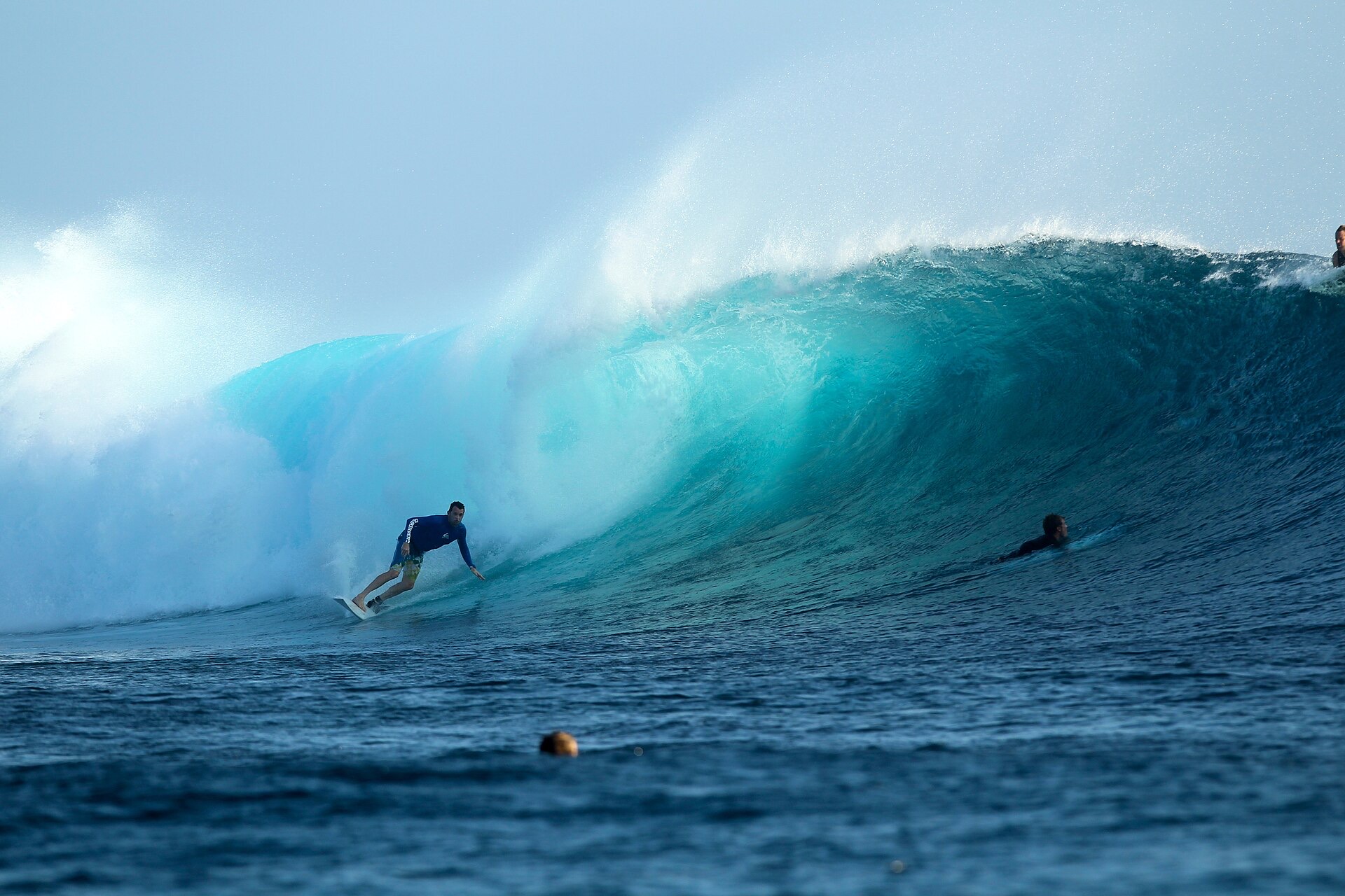 A surfer riding the Cloudbreak reef wave off Tavarua, Fiji